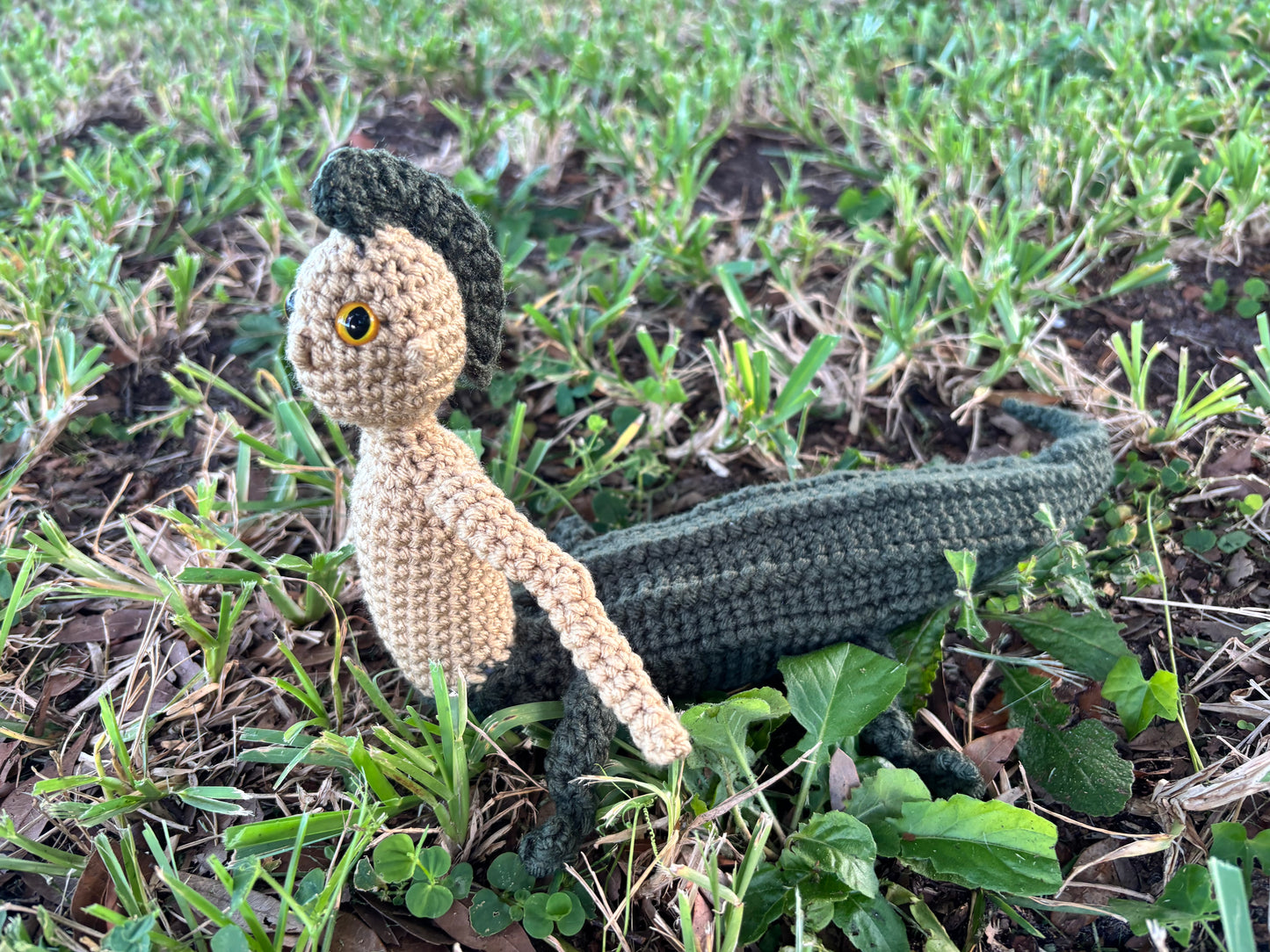 crocheted mergator on grass