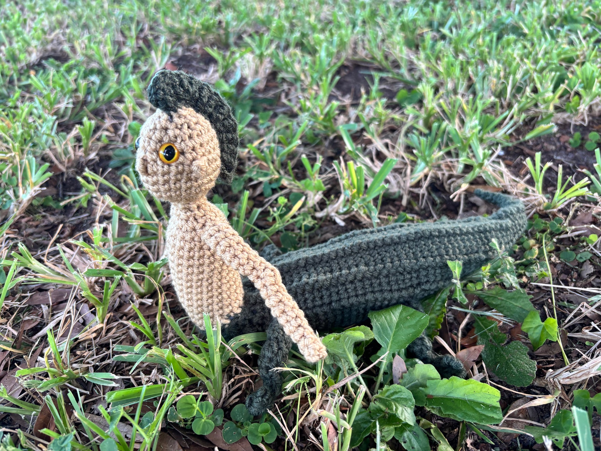 crocheted mergator on grass