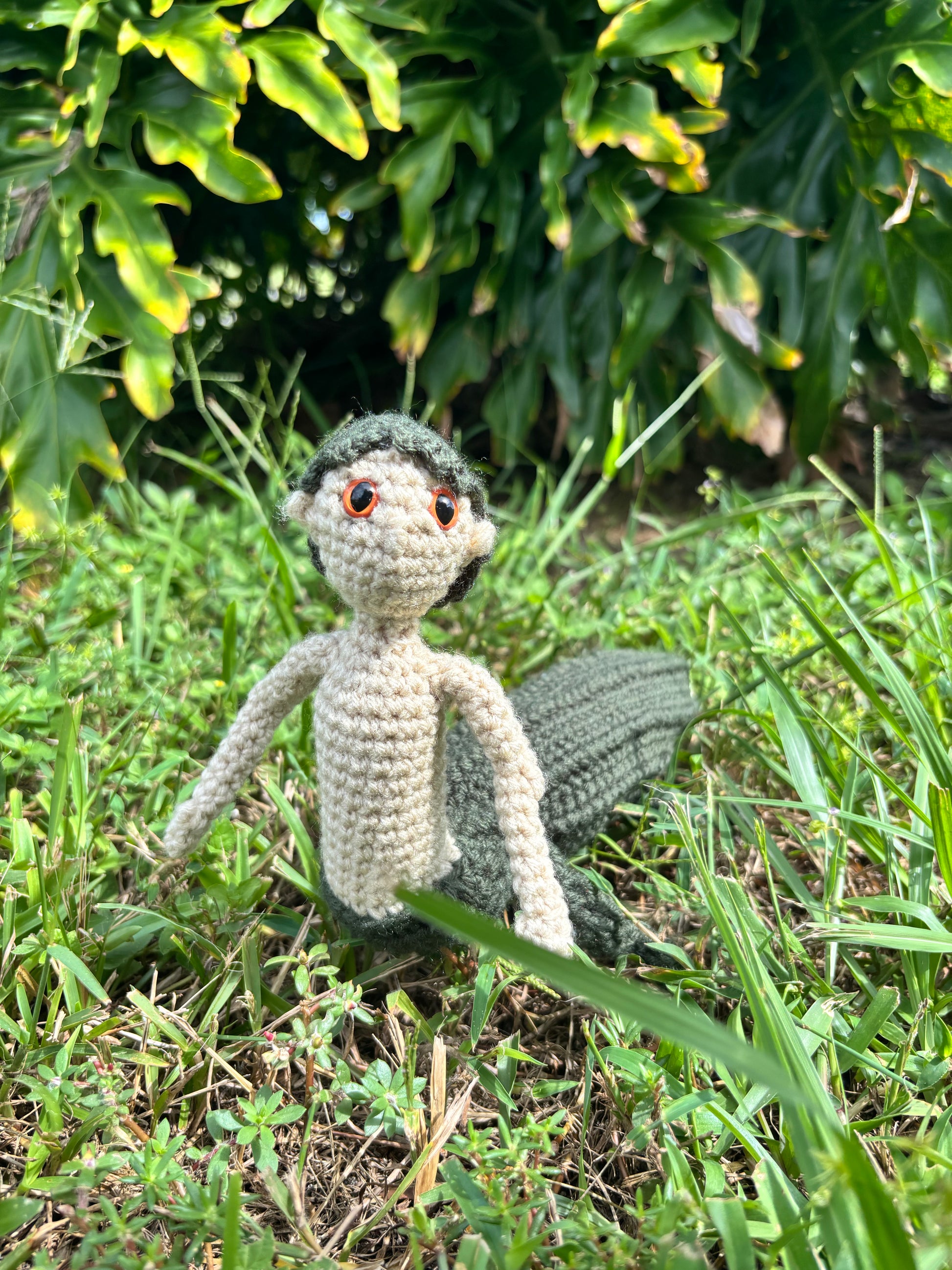 Crocheted mergator in a natural outside setting
