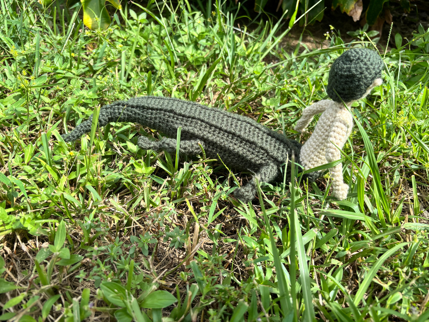 Crocheted mergator on grass